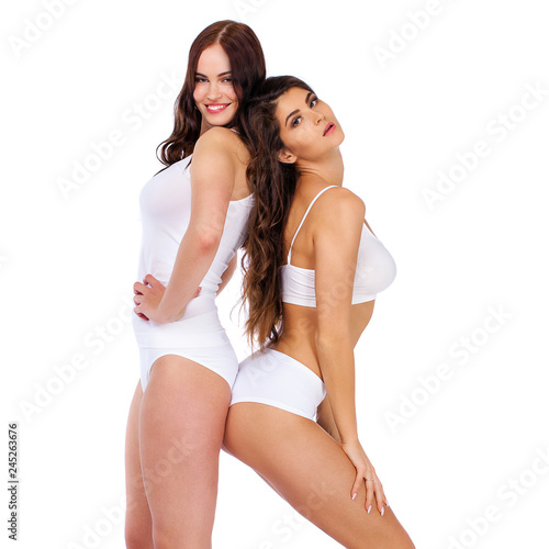 Fitness women. Two young beautiful girlfriends in white sportswear © Andrey_Arkusha
