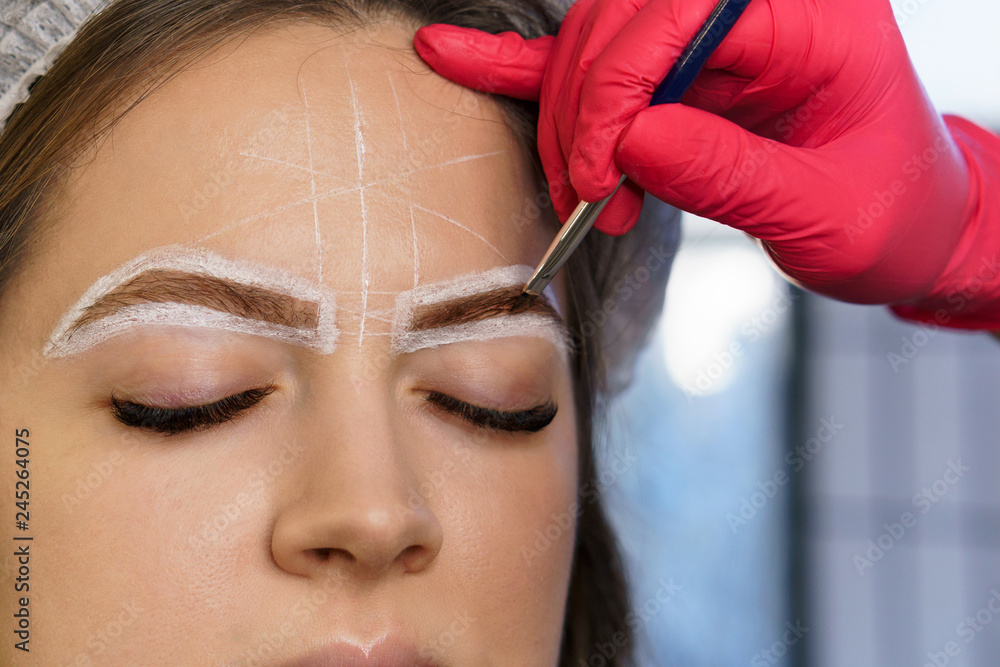 Eyebrow correction. Eyebrow dyeing and hair drawing to create perfect