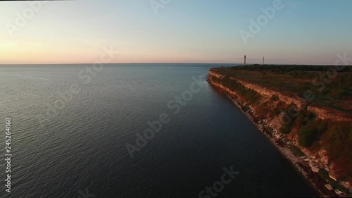 Wallpaper Mural Top aerial drone view of high cliff on the Pakri Peninsula on the Baltic sea in Estonia.  The glare of the sun in the lighthouse reflector. Torontodigital.ca