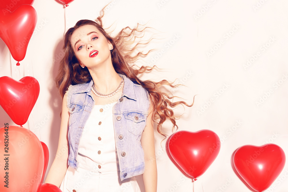Valentine Beauty girl with red air balloons laughing, on white background. Beautiful Happy Young woman. Womans day. Holiday party, dance. Joyful model posing, having fun, celebrating Valentine`s Day. Valentine Beauty girl with red air balloons laughing, on white background. Beautiful Happy Young woman. Womans day. Holiday party, dance. Joyful model posing, having fun, celebrating Valentine`s Day.