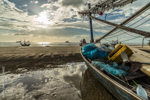 Wooden fishing boat on the beach at Kao Tao, Prachuap Khiri Khan, Thailand. Beautiful sunrise in morning time.