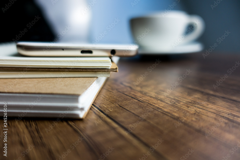 Close up office desk table with laptop, note book, mobile coffee and pen. Selective focus. Business concept. Copy space. Close up office desk table with laptop, note book, mobile coffee and pen. Selective focus. Business concept. Copy space.