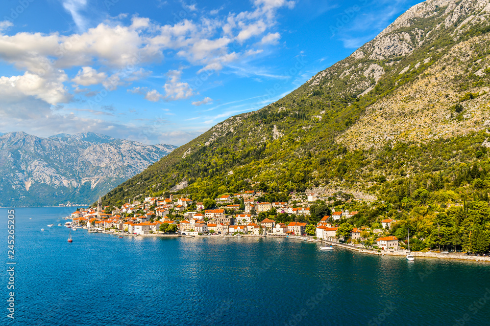 View of the the medieval village of Perast, including the St. Nikola Church tower, along the coast of the Bay of Kotor, Montenegro.