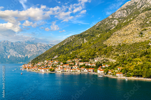 View of the the medieval village of Perast, including the St. Nikola Church tower, along the coast of the Bay of Kotor, Montenegro.