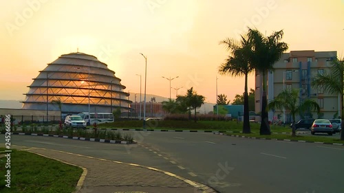 Wide view of a Kigali roundabout at sunset with the convention center dome in front of the sun, Rwanda. photo
