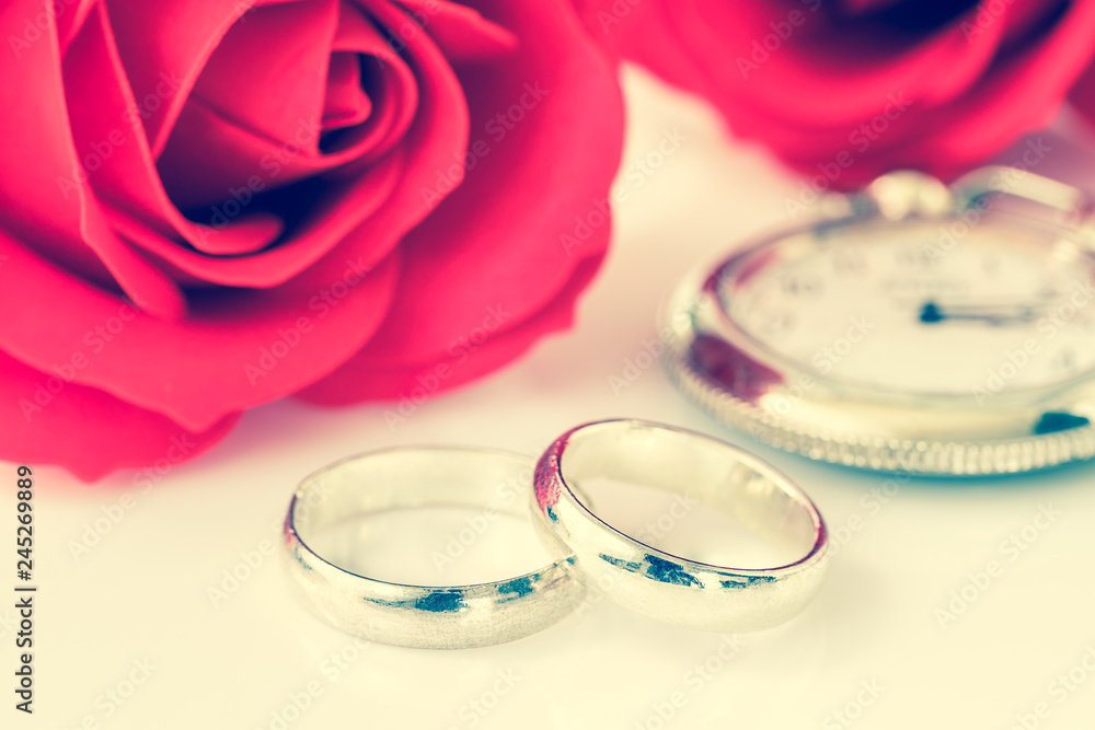 Red rose and wedding ring on white Red rose and wedding ring on white
