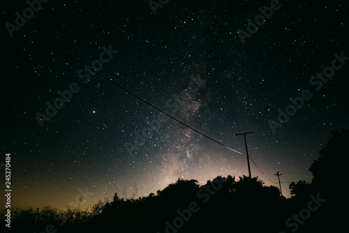 Milky Way over telephone wires on a remote road