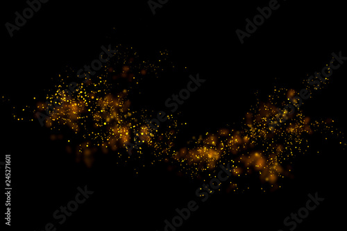 Gold glitter particles lights and bokeh on a black background. Christmas abstract sparkle texture. photo
