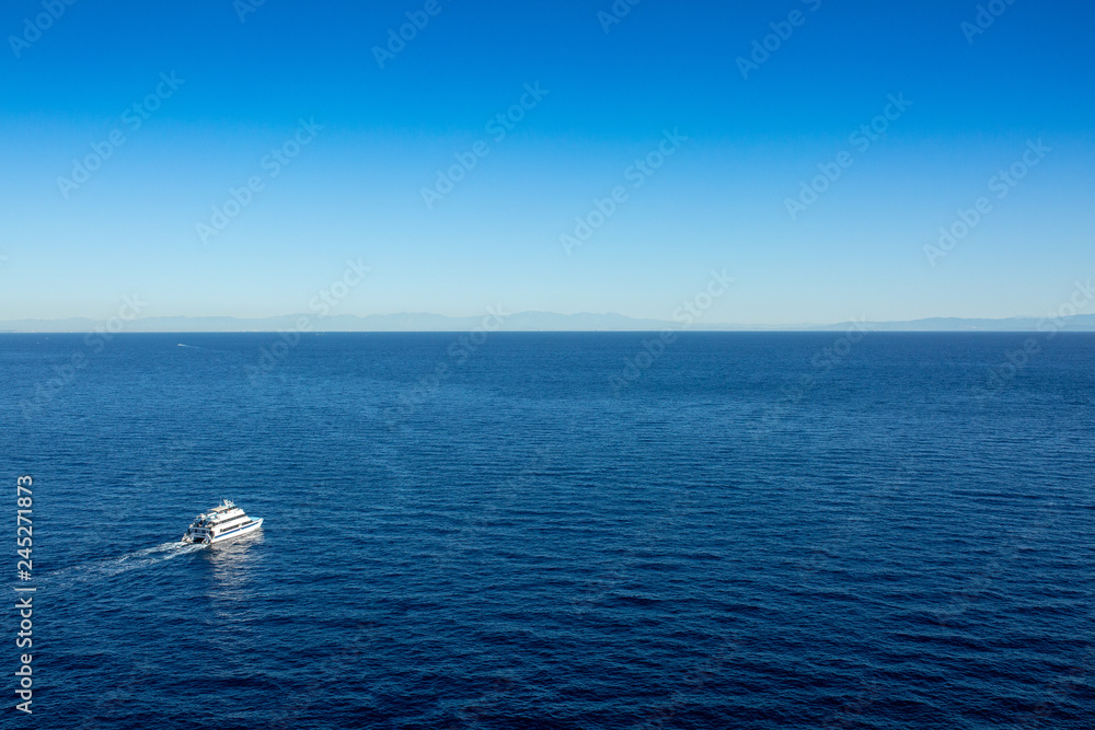 Ferry boat leaving Avalon harbor on Catalina Island in the early sunrise light. Ferry boat leaving Avalon harbor on Catalina Island in the early sunrise light.