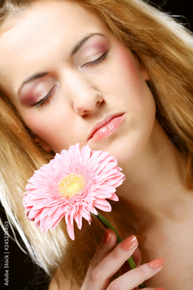 Beautiful young woman with gerber flower