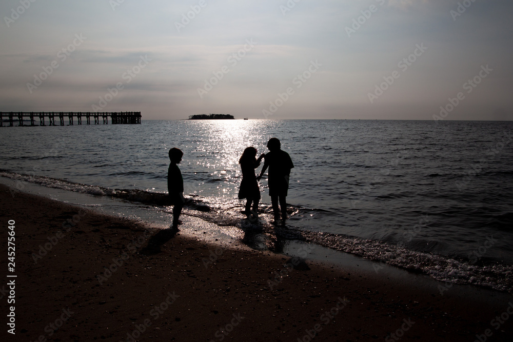 Young Kids on the beach at sunset