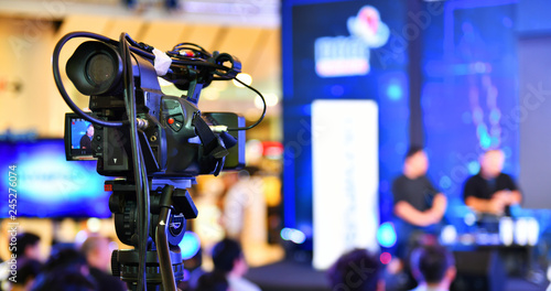 Video recording activity, television cameras in a row broadcasting a live media event. 