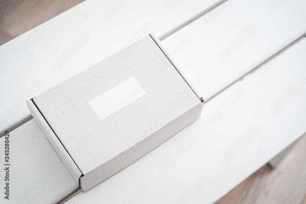 Craft box on white table from above. Product packaging, branding mockup, delivery service. Craft box on white table from above. Product packaging, branding mockup, delivery service.
