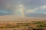 Rainbow appearance during heavy rain over San Pedro de Atacama, Chile, South America. Desert panorama at high altitude under extreme weather conditions.