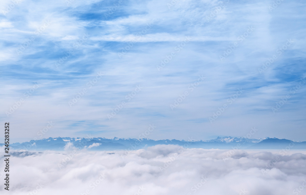 White clouds and Swiss Alps view from Uetliberg lookout tower at Mount Uetliberg, Zurich White clouds and Swiss Alps view from Uetliberg lookout tower at Mount Uetliberg, Zurich