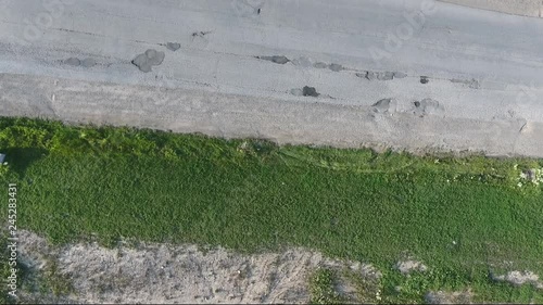 Car Driving On Road With Potholes By Green Area Aerial View photo