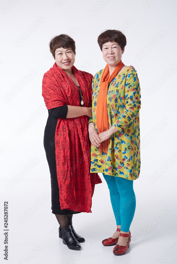 Asian portrait, photo with sisters. Indoors white background