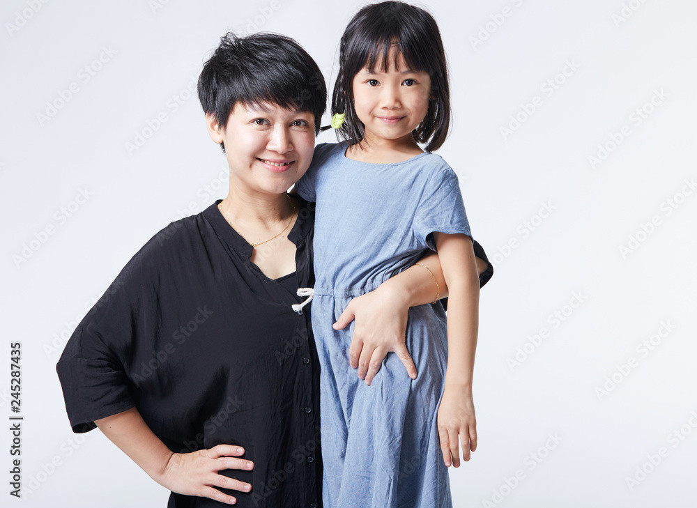 Asian portrait, mother and daughter group photo. Indoors white background Asian portrait, mother and daughter group photo. Indoors white background