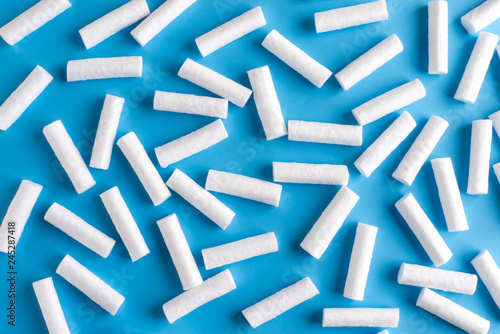 White sterile dental swabs. Dental swabs on blue background.