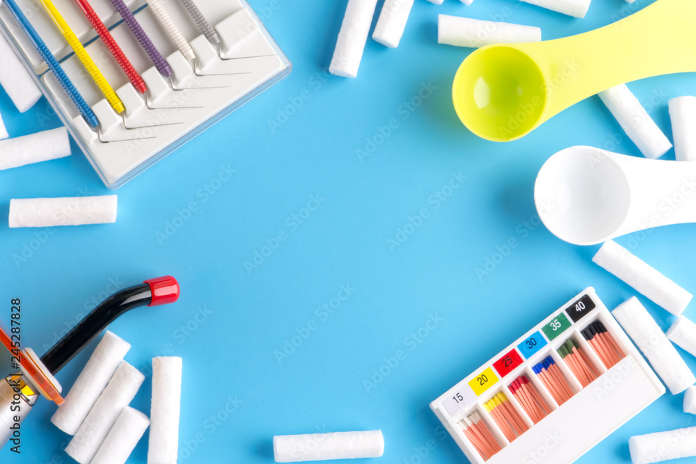 Endodontic instruments on white. Endodontic files. Dental polymerization UV lamp. UV tool