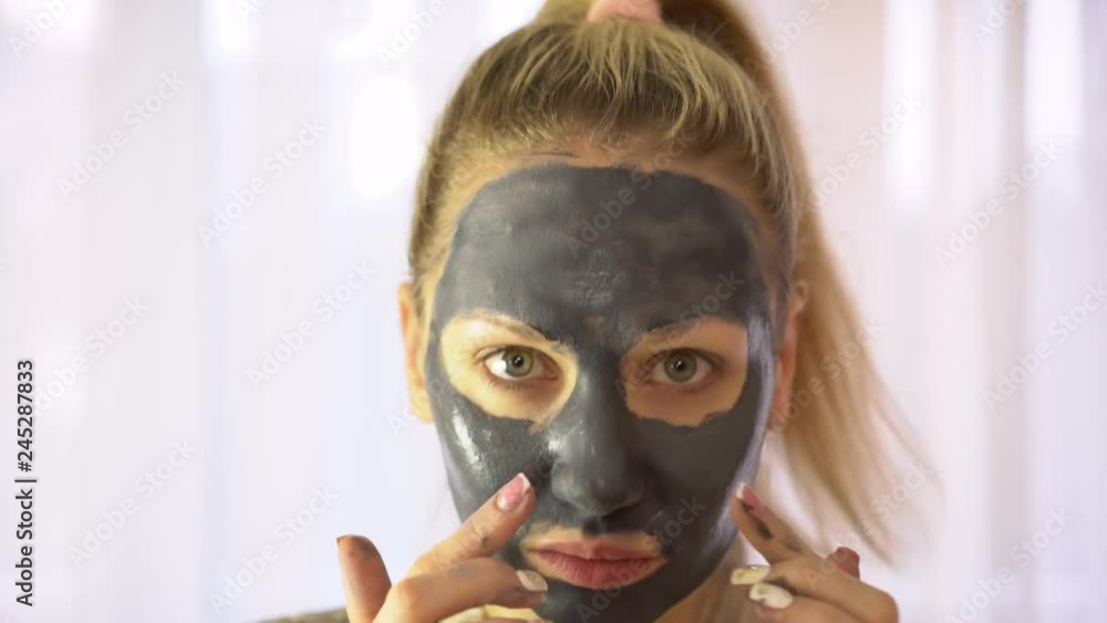 Portrait of a woman with cream or cosmetic mask on her face. Portrait of a woman with cream or cosmetic mask on her face.