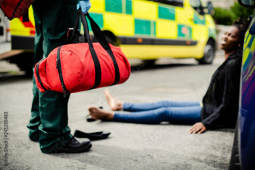 Male paramedic responding to a car accident