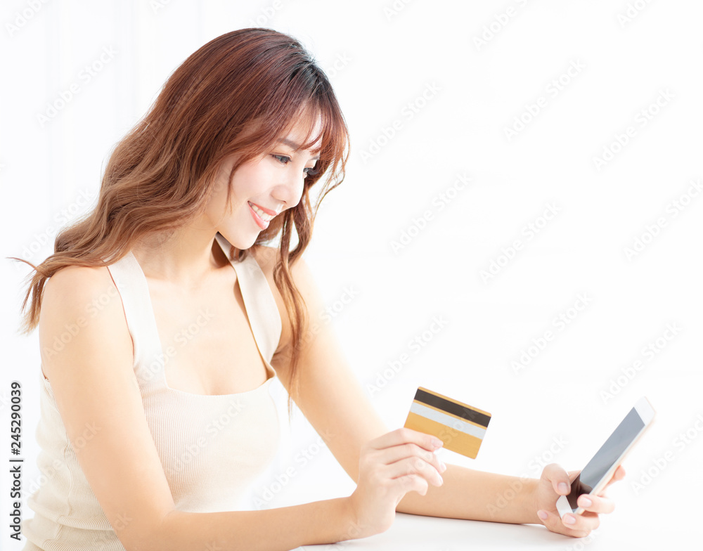 smiling young woman watching mobile phone and credit card smiling young woman watching mobile phone and credit card