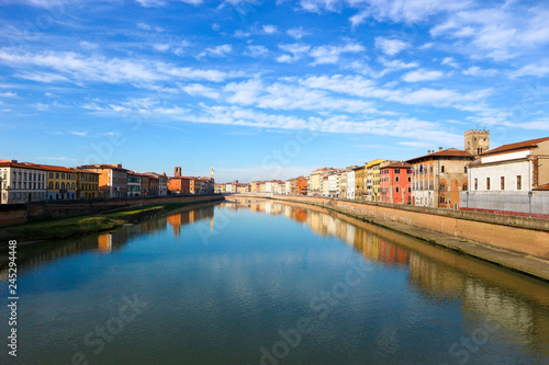 Arno river and colorful houses around under the clear winter sky, Pisa, Tuscany, Italy © Sergei Timofeev