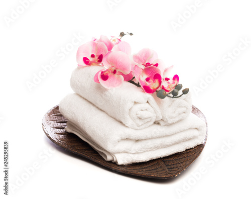 Stack of clean white soft towels with flower on white background - Image. © Fototocam