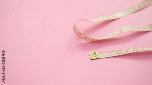 tape measure close up on pink background