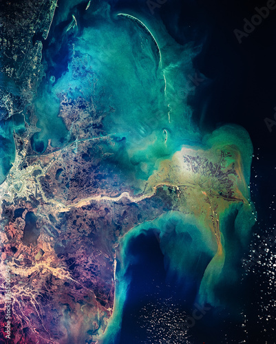 Distribution pattern of muddy fresh water from the Mississippi River as it flows into the Gulf of Mexico. New Orleans. Colorful collage. The elements of this image furnished by NASA.