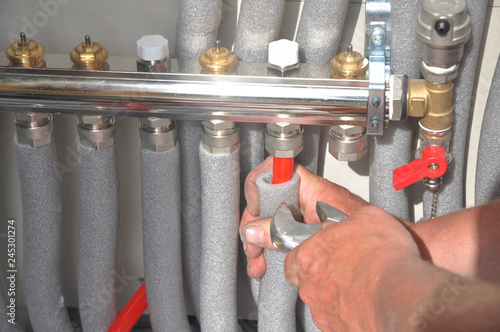 Radiant Floor Heating Installation. Repair floor heating system with insulated metal pipes.