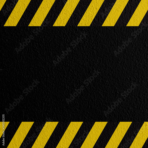 Safety sign yellow and black on mortar texture warning to be careful of the potential danger