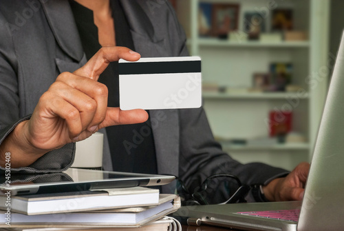 Female businessmen are using credit cards for online purchases.