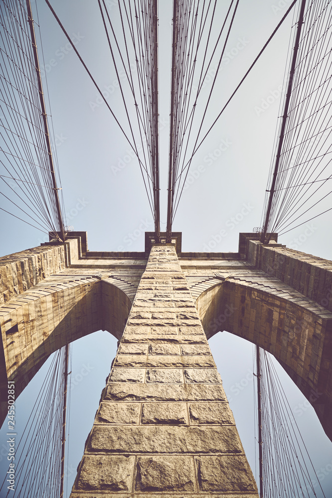 Obraz premium Looking up at Brooklyn Bridge, color toned picture, NYC.