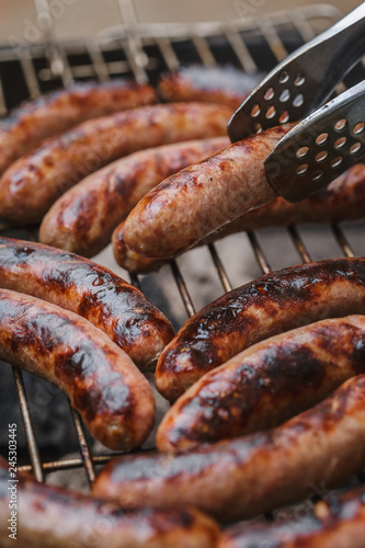 Grilling sausages on barbecue grill outdoor