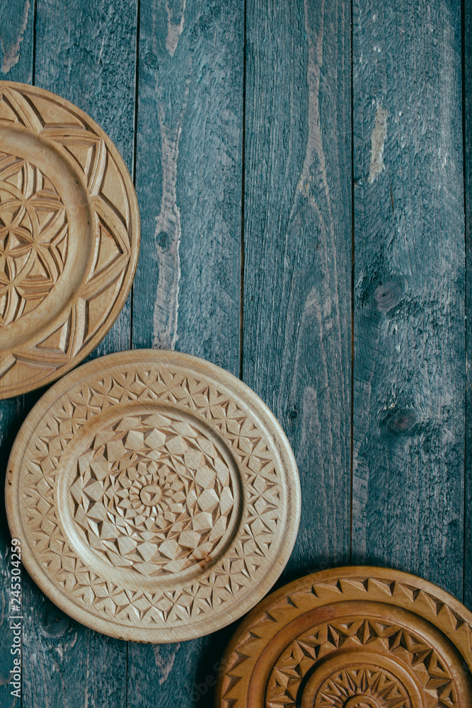 wooden decoration A rounded detailed plate hanging on the wall beautiful plates on a dark wooden background 