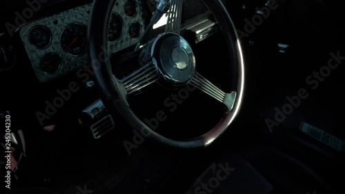 Close up on the interior and steering wheel of an old vintage sports car during the Boucle Historique vintage sports car rally.