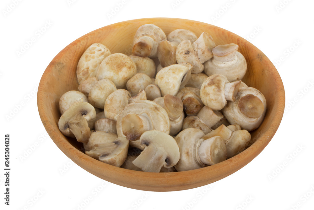 heap of champignons in wooden plate isolated on white background heap of champignons in wooden plate isolated on white background