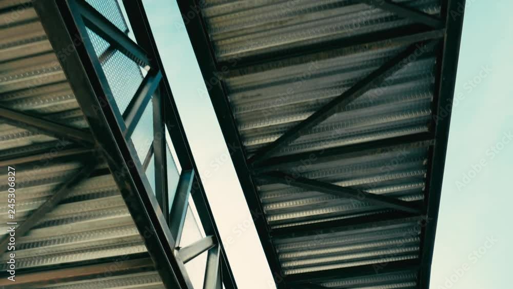 traveling of the metal structure of an industrial walkway seen from below traveling of the metal structure of an industrial walkway seen from below