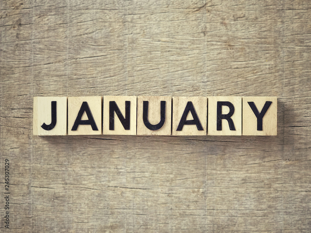 Motivational and inspirational word - ‘JANUARY’written on wooden blocks and arranged on a wooden table. Motivational and inspirational word - ‘JANUARY’written on wooden blocks and arranged on a wooden table.