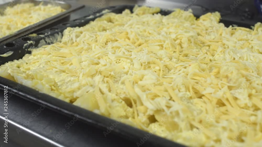 Large pan of potatoes with cheese for cooking in the oven, close-up, 4K Large pan of potatoes with cheese for cooking in the oven, close-up, 4K