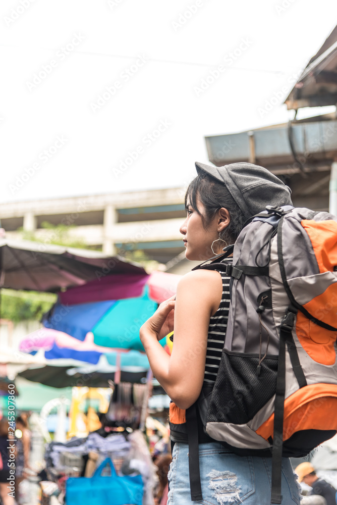 Young Asian cute woman traveler tourist shopping walking on the famous local street market with backpack , food local , vacation,hipster  tourism concept