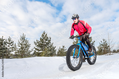 A young man riding fat bicycle in the winter. Fat tire bike.