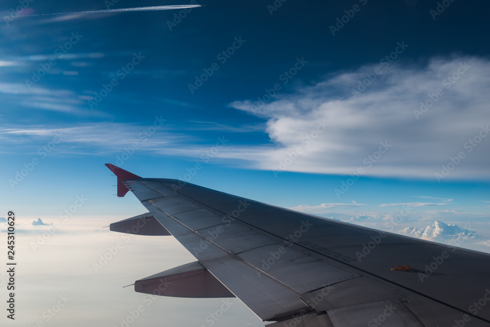 The plane is flying through the sunset sky The plane is flying through the sunset sky