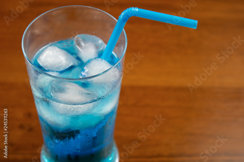 Blue Lagoon cocktail in highball glass with a straw