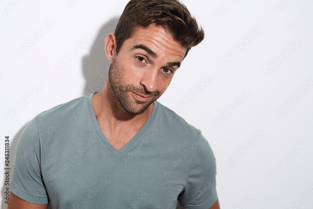 Portrait of stubble guy in grey against white Portrait of stubble guy in grey against white