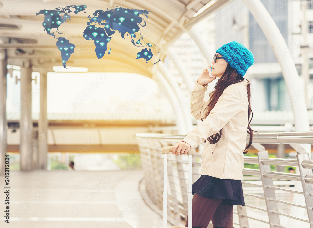 Airport Young passenger woman talking on the mobile phone at gate waiting in terminal while waiting for her flight. Asian casual cheerful woman standing with luggage trolley.Travel concept,copy space Airport Young passenger woman talking on the mobile phone at gate waiting in terminal while waiting for her flight. Asian casual cheerful woman standing with luggage trolley.Travel concept,copy space