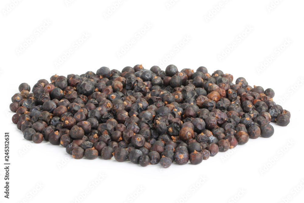 heap of black juniper berries isolated on white background heap of black juniper berries isolated on white background