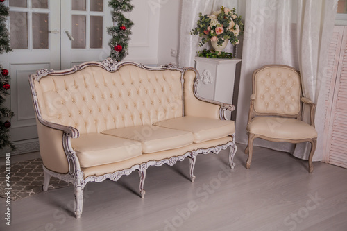 Christmas decoration at home. Beige sofa in the interior of the house
